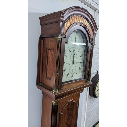 50 - An early 19th century mahogany 8 day longcase clock, having an arched top with pierced grille above ... 