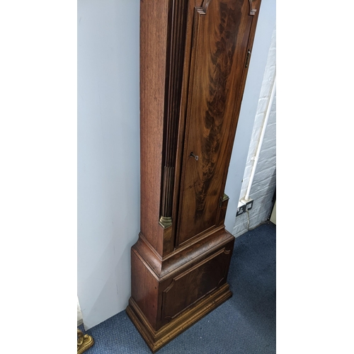 50 - An early 19th century mahogany 8 day longcase clock, having an arched top with pierced grille above ... 