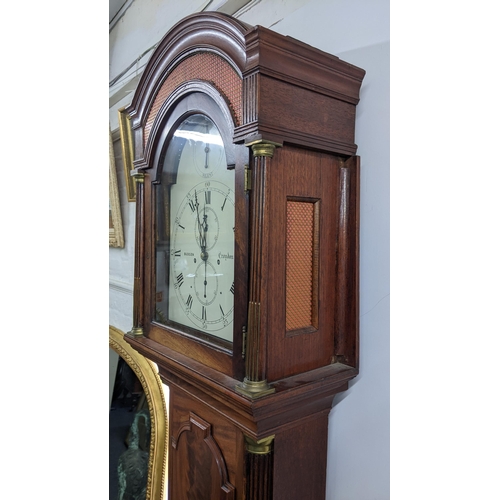 50 - An early 19th century mahogany 8 day longcase clock, having an arched top with pierced grille above ... 