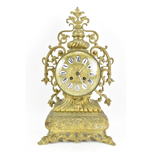 59 - A 19th century French brass mantle clock, the ornate case having pierced floral scroll work frame, t... 