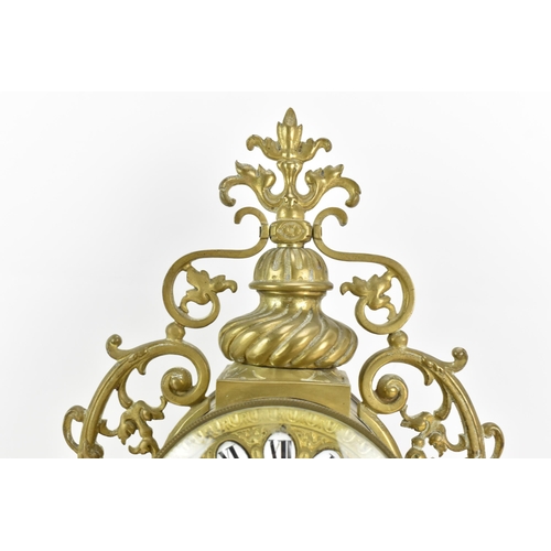 59 - A 19th century French brass mantle clock, the ornate case having pierced floral scroll work frame, t... 