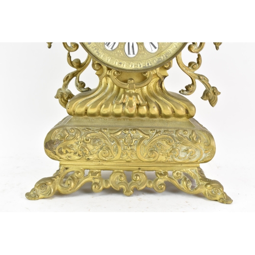 59 - A 19th century French brass mantle clock, the ornate case having pierced floral scroll work frame, t... 