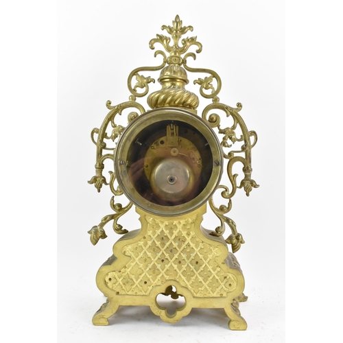 59 - A 19th century French brass mantle clock, the ornate case having pierced floral scroll work frame, t... 