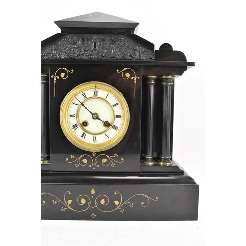 65 - A late 19th century French 8 day mantle clock, the case of architectural form with a scene of cherub... 