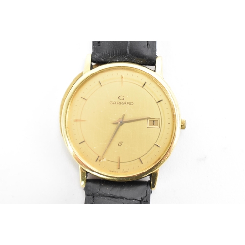 72 - A Garrard, quartz, gents, 18ct gold wristwatch, circa 1989, having a gilt dial with baton markers an... 