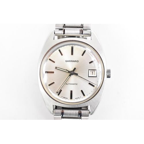 73 - A Garrard, automatic, gents, stainless steel wristwatch, circa 1974, having a silvered dial with bat... 