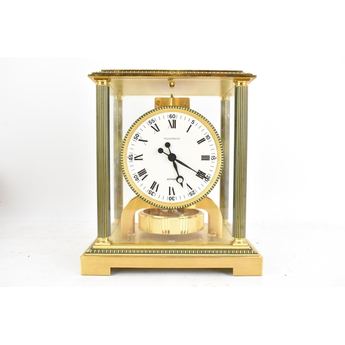 76 - A Jaeger LeCoultre Atmos clock, in a gilt brass case with reeded columns flanking the circular white... 