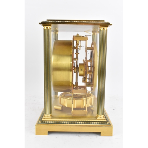 76 - A Jaeger LeCoultre Atmos clock, in a gilt brass case with reeded columns flanking the circular white... 