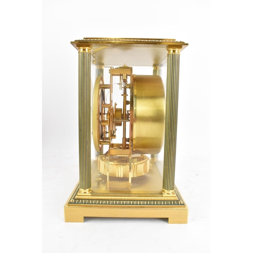 76 - A Jaeger LeCoultre Atmos clock, in a gilt brass case with reeded columns flanking the circular white... 