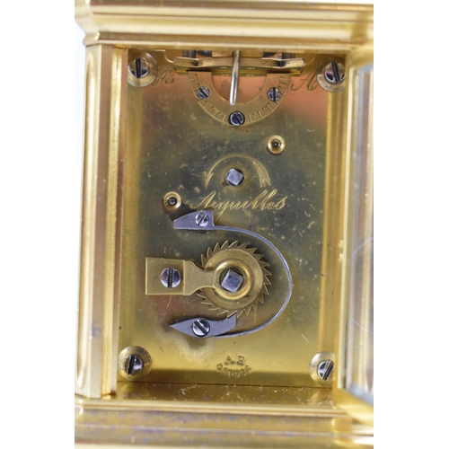 83 - A late 19th century French gilt metal miniature carriage clock, having machine turned decoration and... 