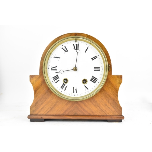 84 - An early 20th century walnut 8 day mantle clock, the white enamel dial having black Roman numerals w... 