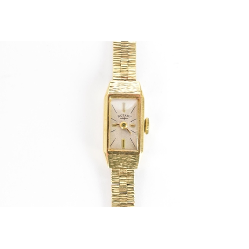 9 - A Rotary, manual wind, ladies, 9ct gold wristwatch, having a rectangular dial with baton markers, on... 