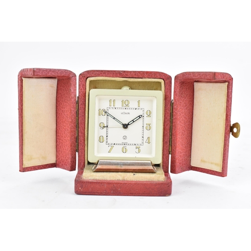 93 - A LeCoultre 2 manual wind alarm travel clock in a fitted case, with a cream dial and Arabic numerals... 