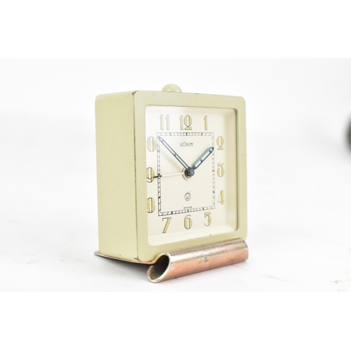 93 - A LeCoultre 2 manual wind alarm travel clock in a fitted case, with a cream dial and Arabic numerals... 