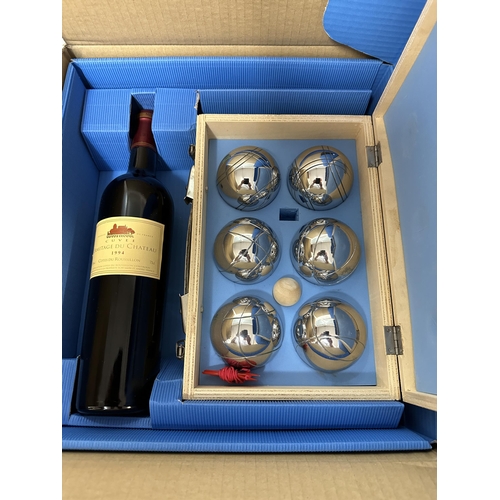 54 - A single bottle of Ermitage du Chateau Cotes du Roussillon 1994 and a wooden cases of Boule balls,  ... 