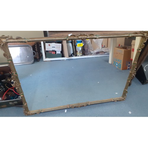 325 - A mid 20th Century gilt and painted mirror 70cm x 105cm, having painted floral sprays to the corners... 