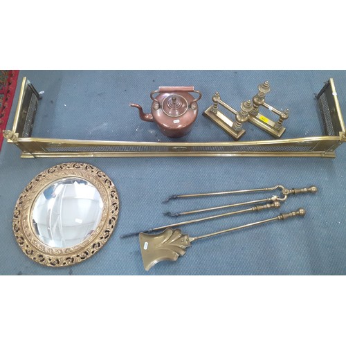 316 - A Victorian copper kettle, brass fire irons, a brass fire surround and a pair of brass fireside dogs... 