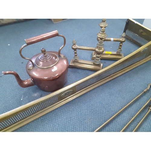 316 - A Victorian copper kettle, brass fire irons, a brass fire surround and a pair of brass fireside dogs... 