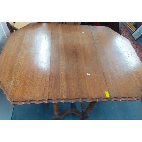 320 - An early 20th Century oak dining table with barley twist supports and drop down sides, 75cm High x 1... 