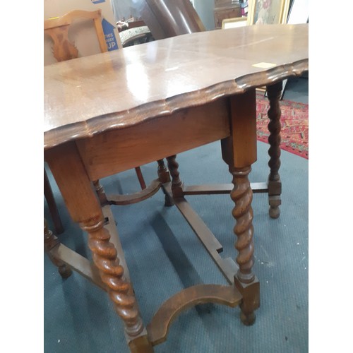 320 - An early 20th Century oak dining table with barley twist supports and drop down sides, 75cm High x 1... 