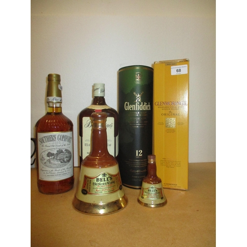 166 - One bottle of Southern Comfort, two Bells flasks, one bottle of Ballantines finest scotch whisky 112... 