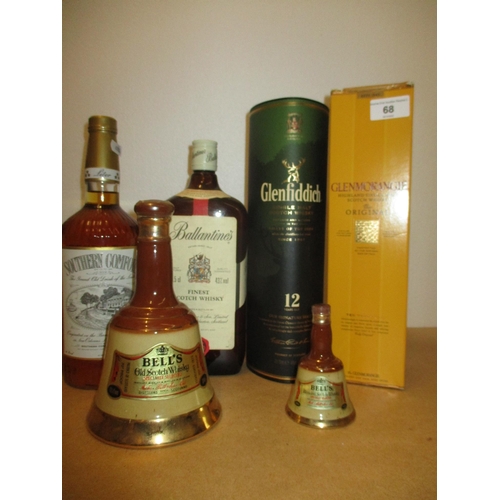 166 - One bottle of Southern Comfort, two Bells flasks, one bottle of Ballantines finest scotch whisky 112... 