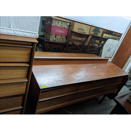 275 - A mid-century teak dressing table with mirror, possibly Austinsuite, the base with six short drawers... 