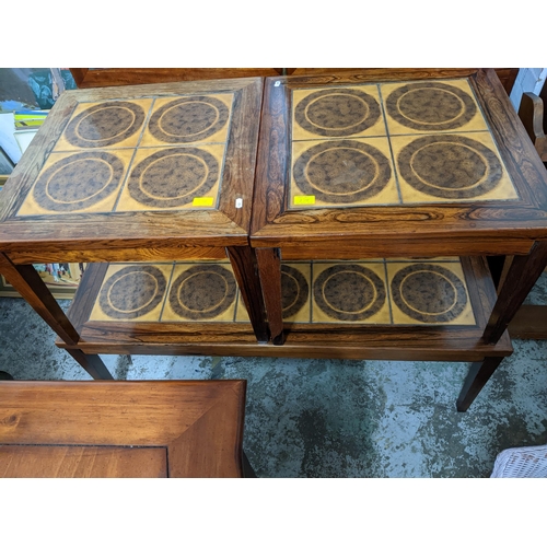 278 - A Moluna Mobler Danish rosewood and tile topped nest of three coffee tables, the largest 41cm x 116c... 