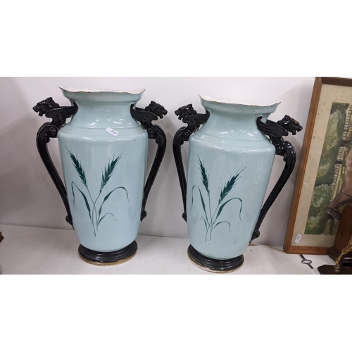 300 - Circa 1900, a pair of twin handled large turquoise glazed vases decorated with scenes of figures, 39... 