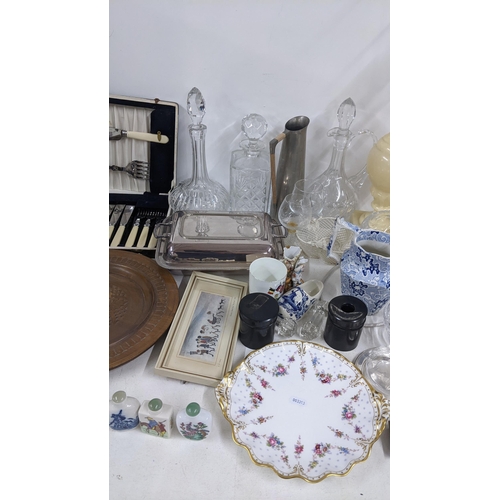 338 - A mixed lot to include a silver plated entree dish, Chinese scent bottles, decanters, signed engravi... 