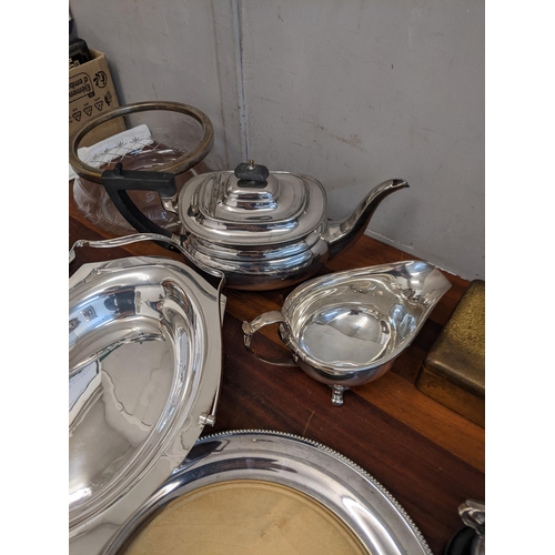 361 - A collection of silver plate items to include three trays, a tea pot, a condiment set, milk jugs and... 