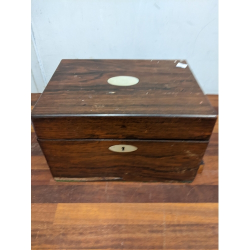 363 - A late 19th/early 20th century vanity box with many compartments, pull-out drawer and mother of pear... 