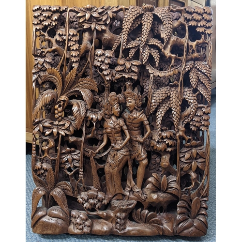 371 - An Indonesian treen carved wall hanging panel of two figures in a forest scene, 49.5cm x 38.5cm
Loca... 