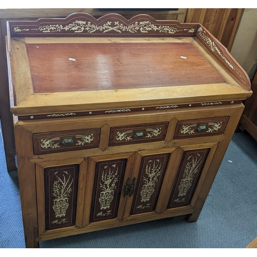 373 - A Chinese cabinet having a raised gallery, three drawers and two cupboard doors, inlaid with bone, 9... 