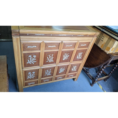 375 - A Chinese pine cabinet, the front inlaid with bone panels and having a hinged top revealing storage ... 