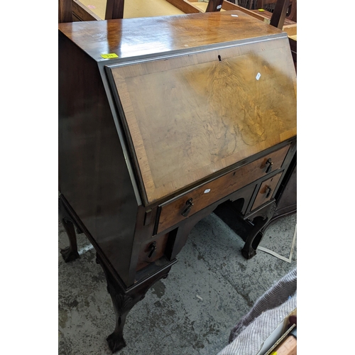 276 - A 1920s Queen Anne style bureau with fall flap open pigeonholes and short drawers with one long draw... 