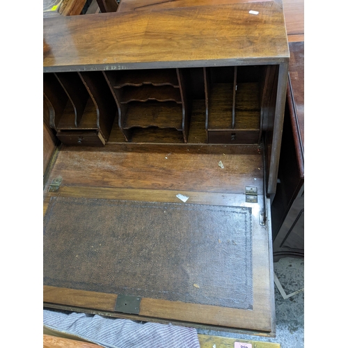 276 - A 1920s Queen Anne style bureau with fall flap open pigeonholes and short drawers with one long draw... 