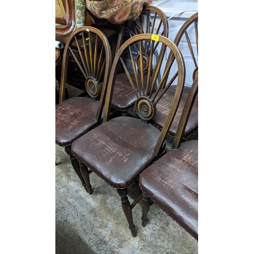 281 - A set of six early 20th century Windsor target and fan back dining chairs with leather upholstered s... 