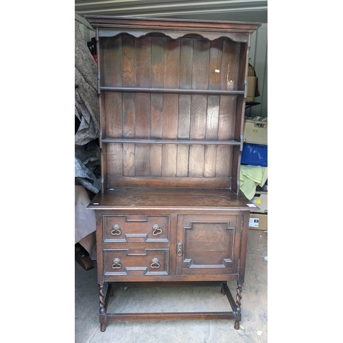 380 - An early 20th century oak dresser having a plate rack above drawers and a cupboard door A/F, 173.5cm... 