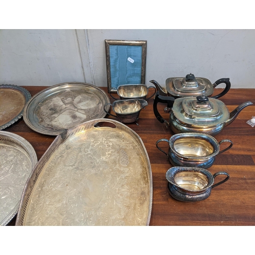 368 - A collection of silver plated items to include two tea sets, six tea trays, and a photo frame Locati... 