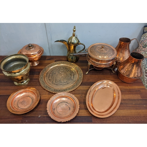 369 - A collection of copperware to include two jugs, plates, a burner stand, a brass pot, and other items... 