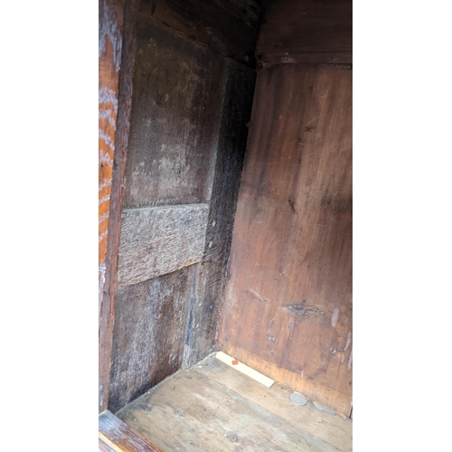 430 - An early 20th century Jacobean style oak court cupboard having a moulded cornice, panelled doors, wr... 