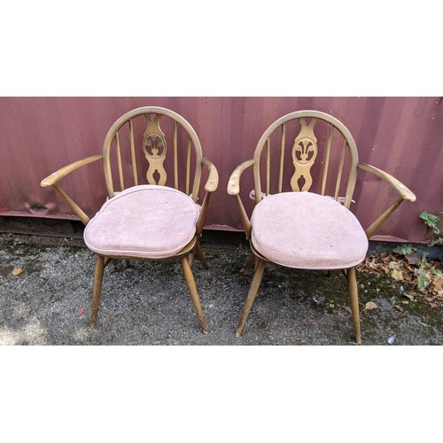 531 - Two office swivel chairs and a pair of mid 20th century Ercol beech stained spindle back armchairs
L... 