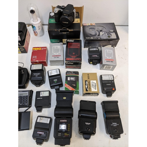 496 - Photographic equipment to include a boxed Minolta Vecitis 300, a boxed Fujifilm Finepix 58100 FD, va... 