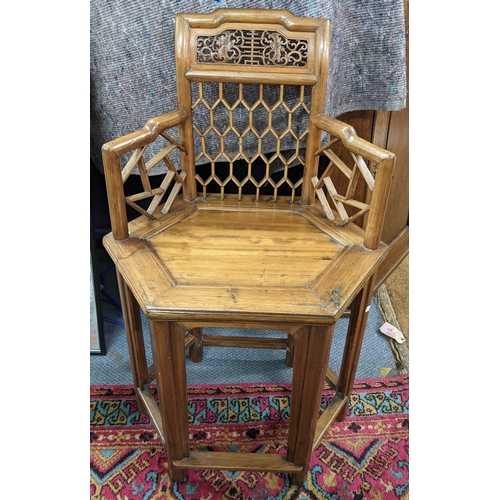 388 - A Chinese pine hexagonal seated armchair having bamboo style frame and a pierced scroll top rail
Loc... 