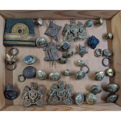 445 - Military cap badges and buttons and regiment name badges, along with a table top display case (glass... 