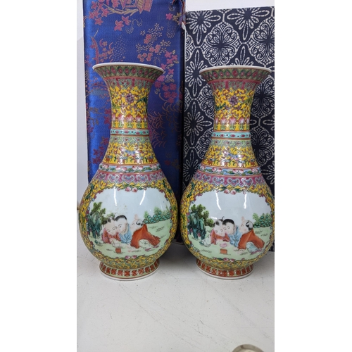 454 - A pair of 20th century Chinese famille rose baluster porcelain vases, each having panels painted wit... 