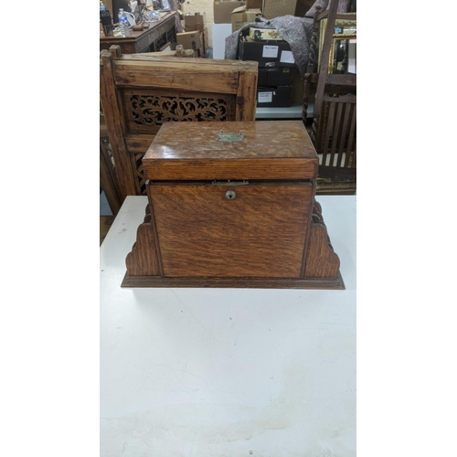 485 - A late 19th/early 20th century oak table top stationery box with fitted compartments and letter rack... 