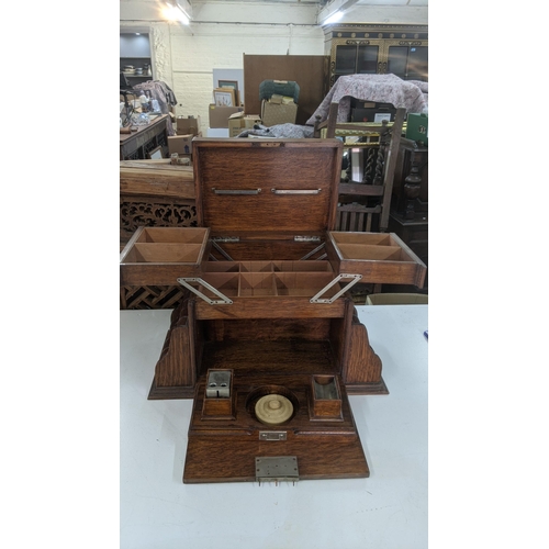 485 - A late 19th/early 20th century oak table top stationery box with fitted compartments and letter rack... 