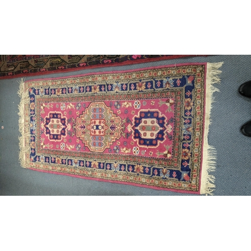 553 - Two handwoven rugs to include a Turkish red ground runner having floral motifs, 300cm x 86cm, the ot... 